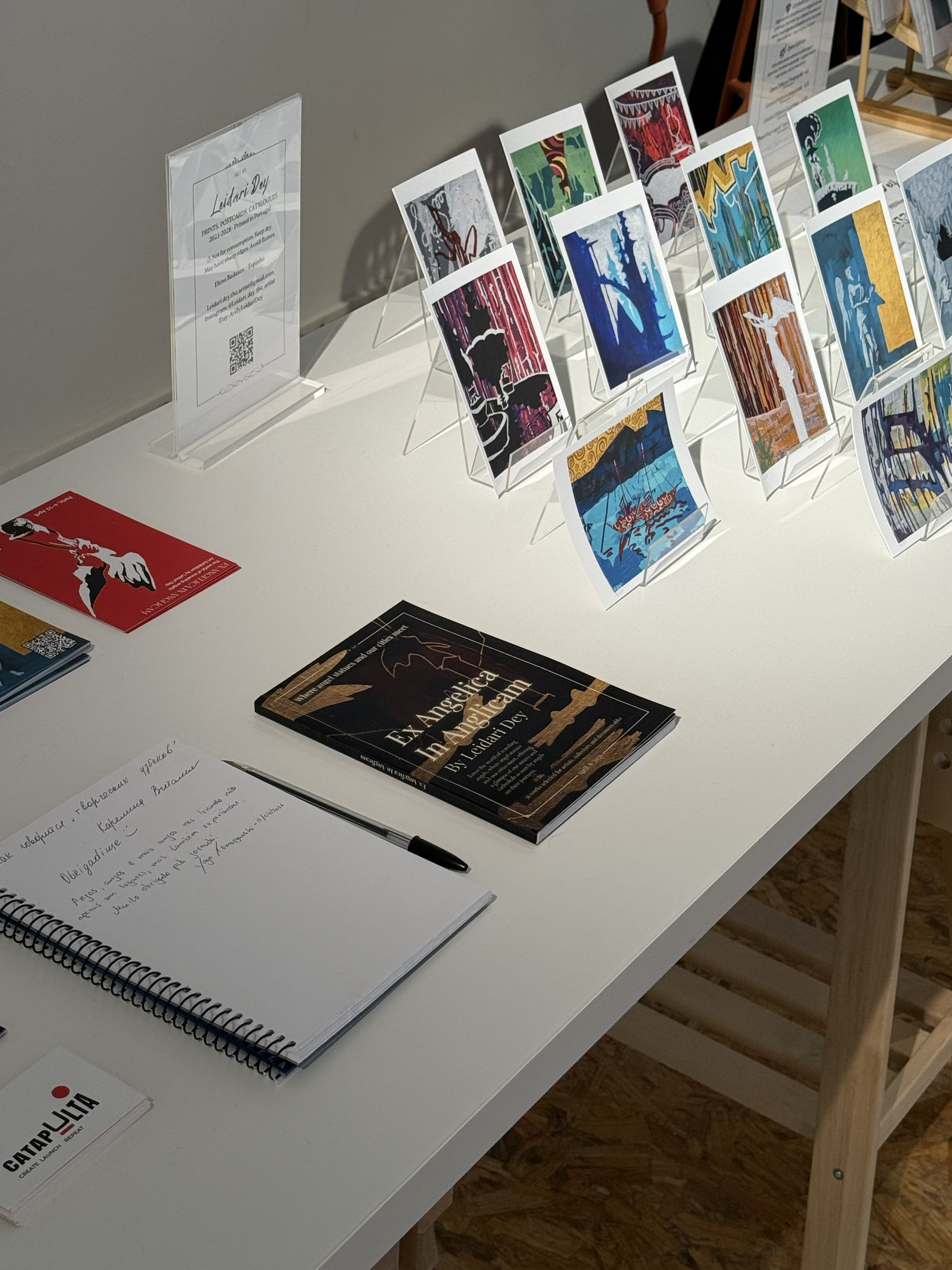 Art prints and an exhibition catalogue on a table